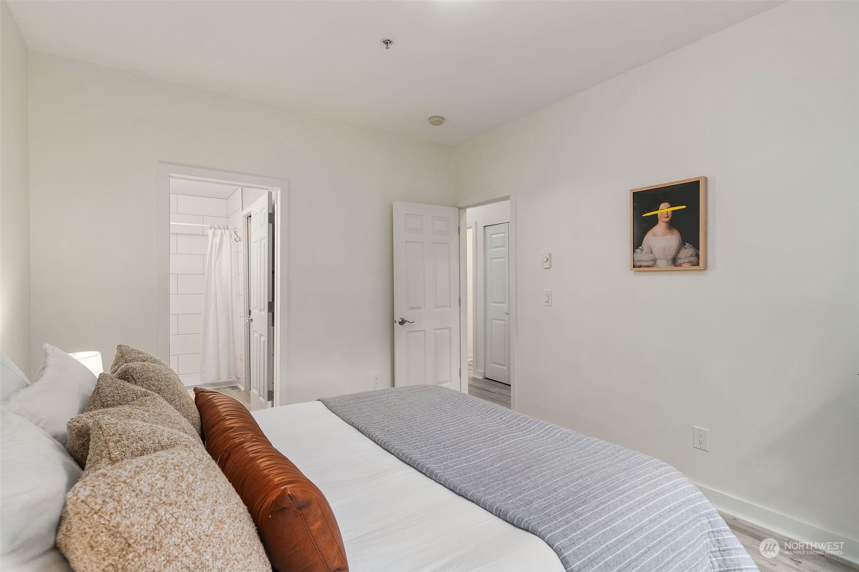 18930 Bothell Everett Highway, Unit C101 Bothell, WA 98012 - Photo 16 of 36 a bedroom with a bed and a painting on the wall