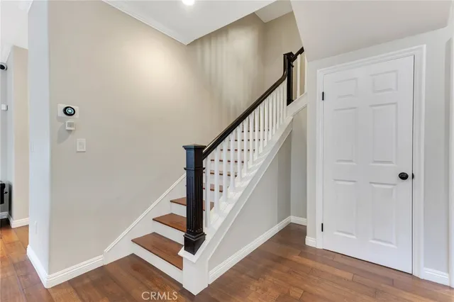 a view of entryway with wooden floor and stairs