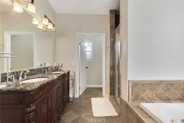 a spacious bathroom with a bathtub a sink and a mirror