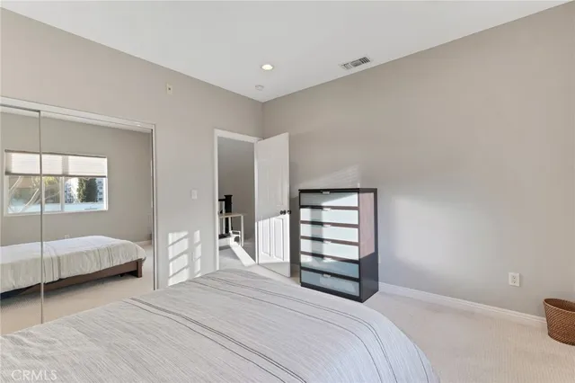 a bathroom with a granite countertop toilet sink and mirror
