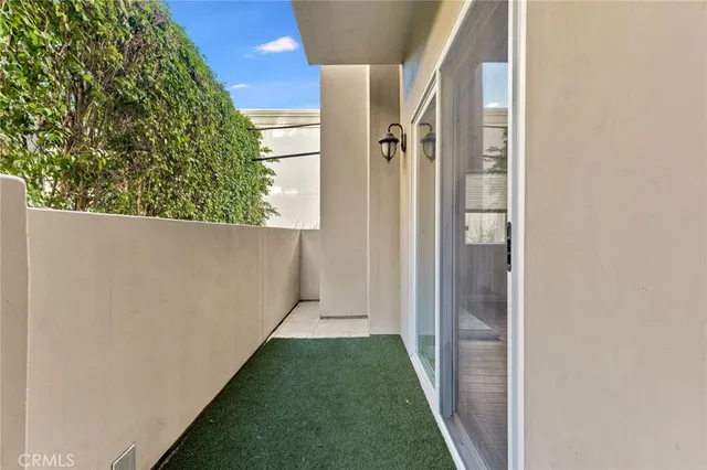 a view of a back yard from a corridor