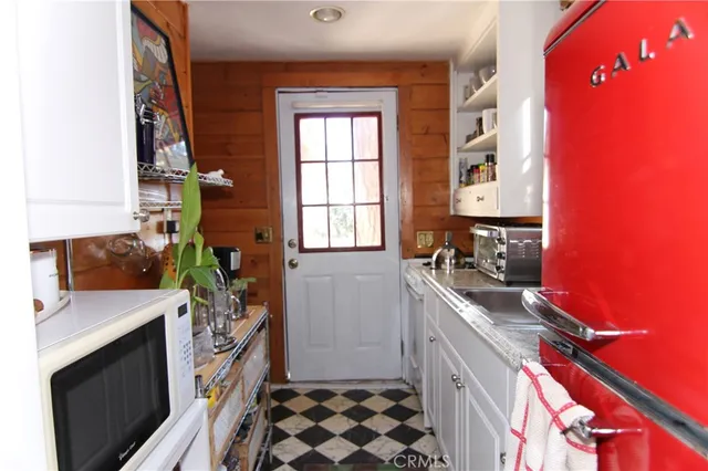 a kitchen with a sink stove and refrigerator