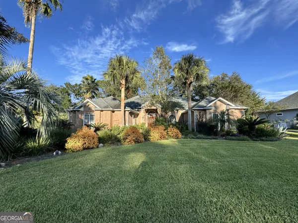 a view of a park with a house in the background