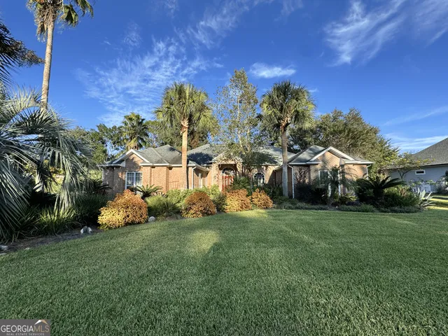 a view of a park with a house in the background