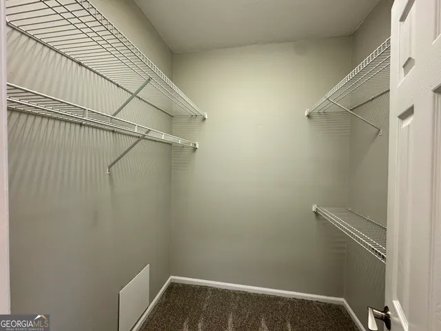 a spacious bathroom with a granite countertop tub sink and mirror