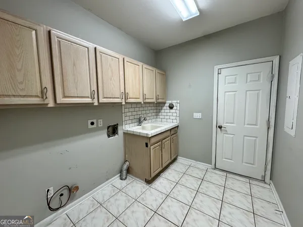 a view of a yard with plants and a bench