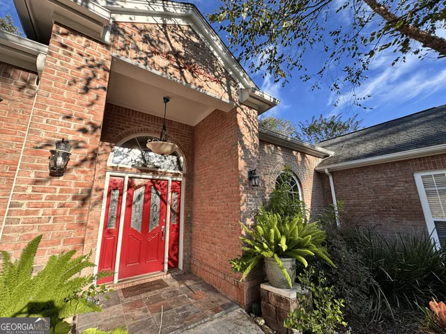 a front view of a house with plants