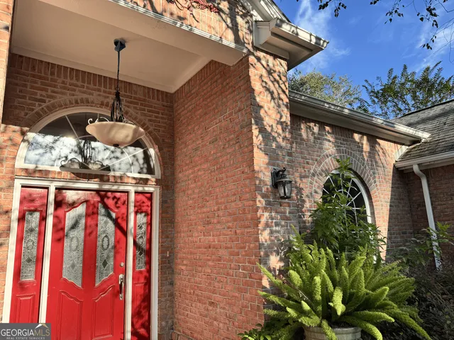 a view of a livingroom with wooden floor a fireplace and window