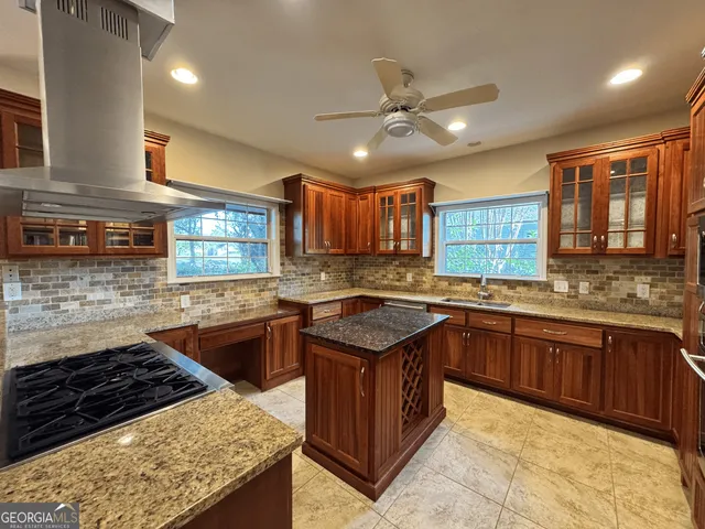a kitchen with stainless steel appliances granite countertop a stove refrigerator and cabinets