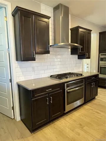 a kitchen with stainless steel appliances granite countertop a sink stove and microwave