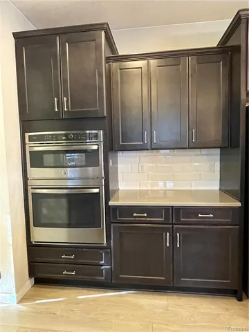 a kitchen with granite countertop a stove and a microwave