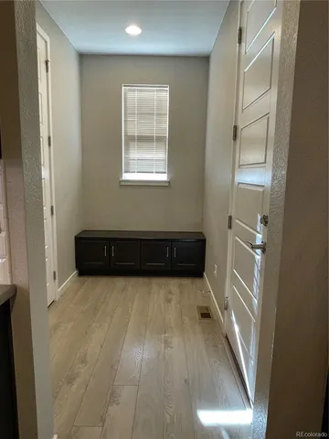 a view of an empty room with wooden floor