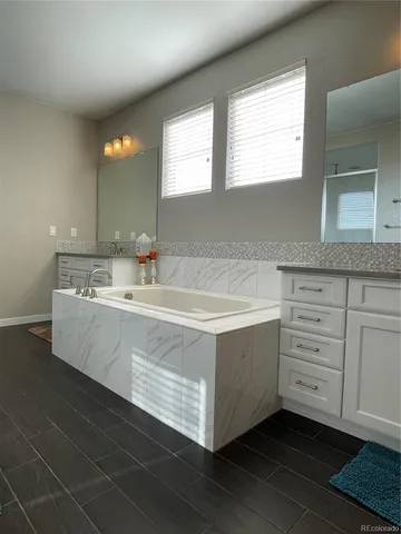 a bathroom with a glass shower door and a window