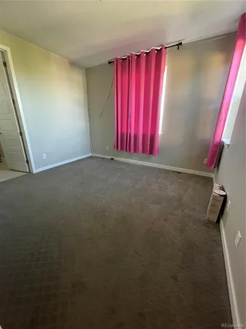 a bathroom with a granite countertop toilet a sink a mirror a window and a shower