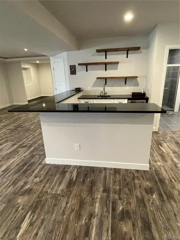 a kitchen with stainless steel appliances granite countertop a sink and a stove