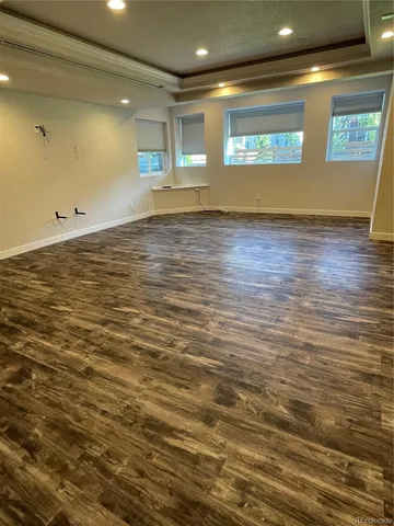 a view of a room with wooden floor and a window