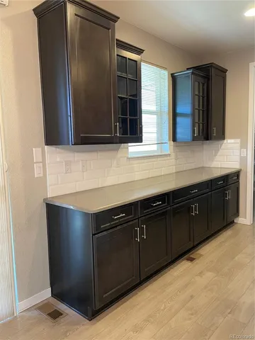 a kitchen with granite countertop cabinets and window
