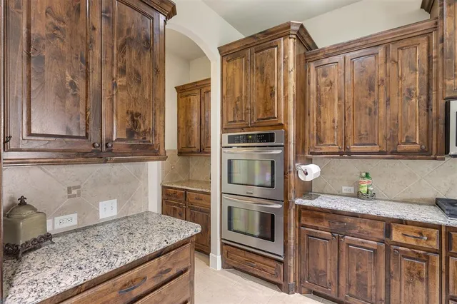 a kitchen with stainless steel appliances wooden cabinets and a counter top