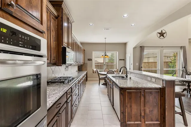 a kitchen with sink stove and cabinets