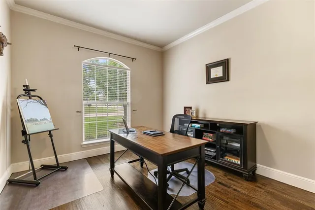 a view of a workspace with furniture and a window
