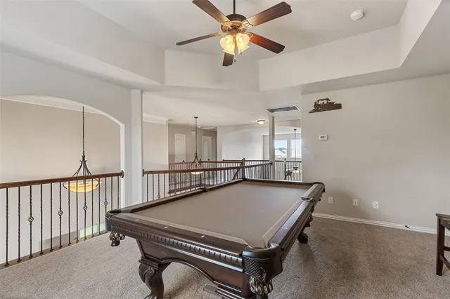 a room with pool table and windows