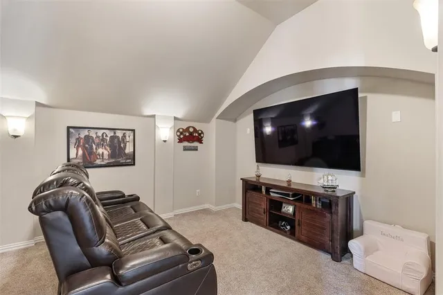 a projector room with furniture and a flat screen tv