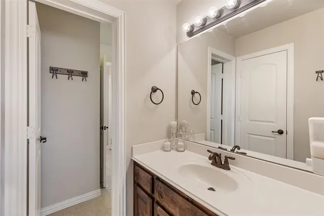 a bathroom with a double vanity sink mirror and shower