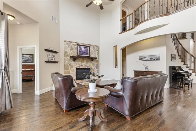 a living room with fireplace furniture and a wooden floor