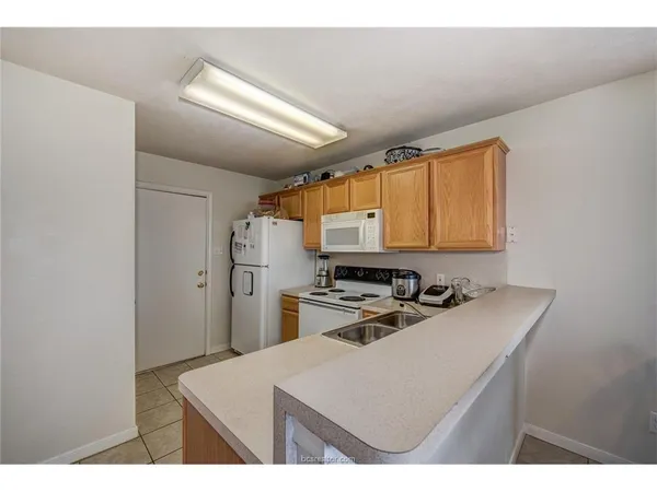 a kitchen with a sink appliances and cabinets