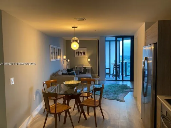 a view of a dining room with furniture and wooden floor