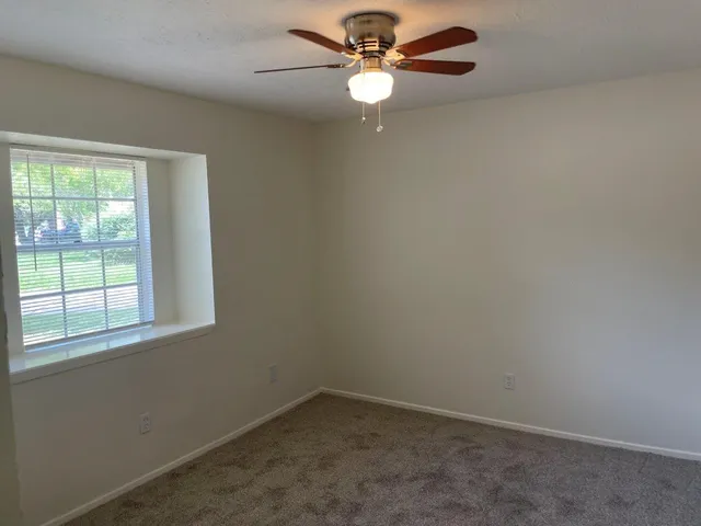 a view of backyard with wooden fence