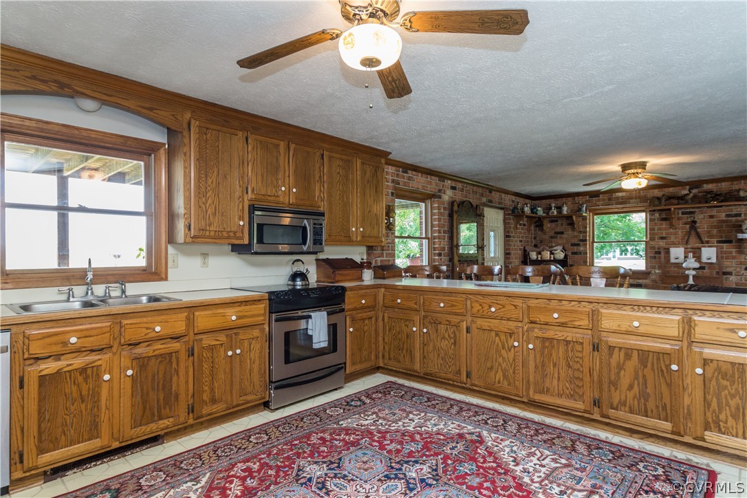 22 Foxes Tract Road West Point, VA 23181 - Photo 13 of 36 a kitchen with stainless steel appliances granite countertop wooden cabinets a dining table and chairs
