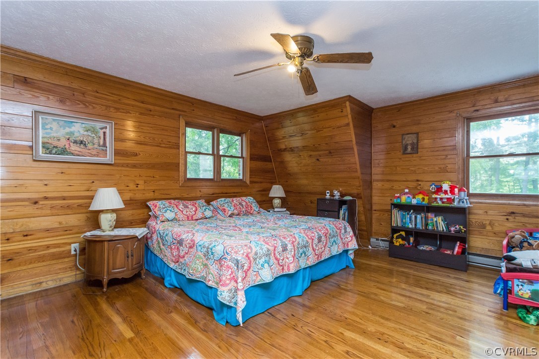 22 Foxes Tract Road West Point, VA 23181 - Photo 19 of 36 a bedroom with a bed and wooden floor