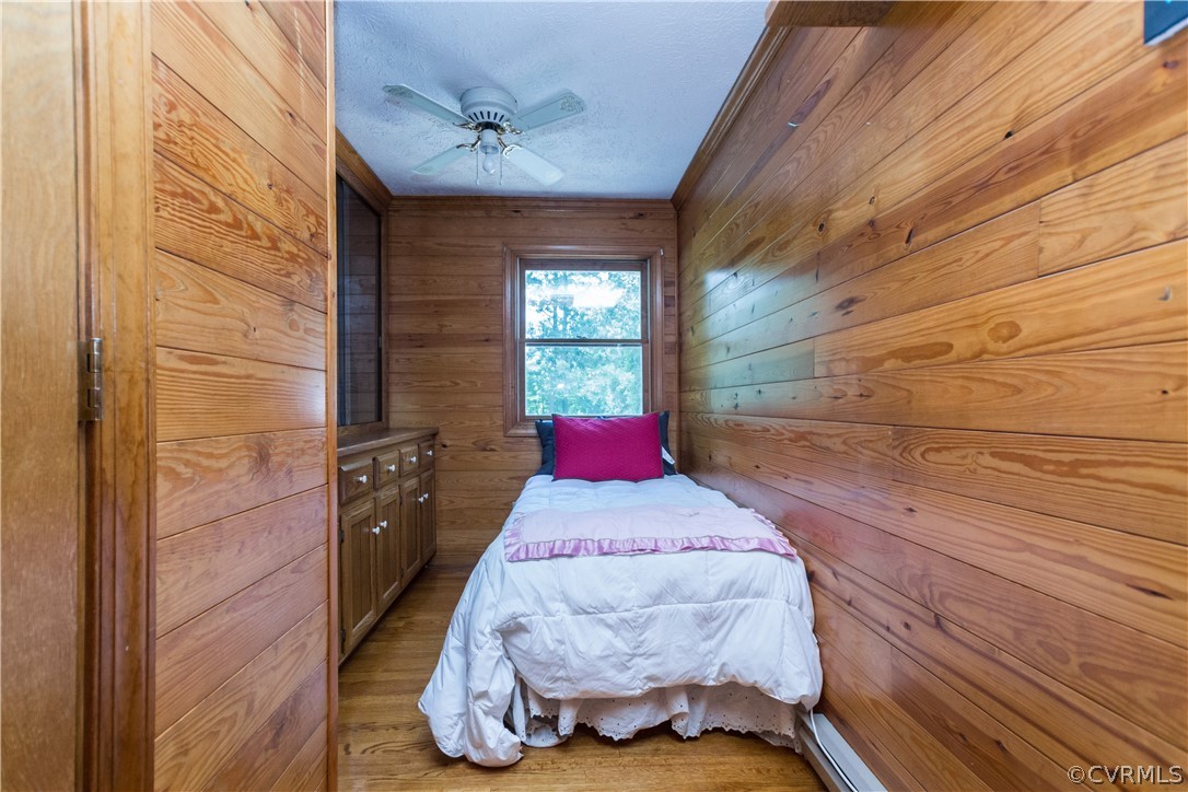 22 Foxes Tract Road West Point, VA 23181 - Photo 24 of 36 a bedroom with a bed and a chandelier