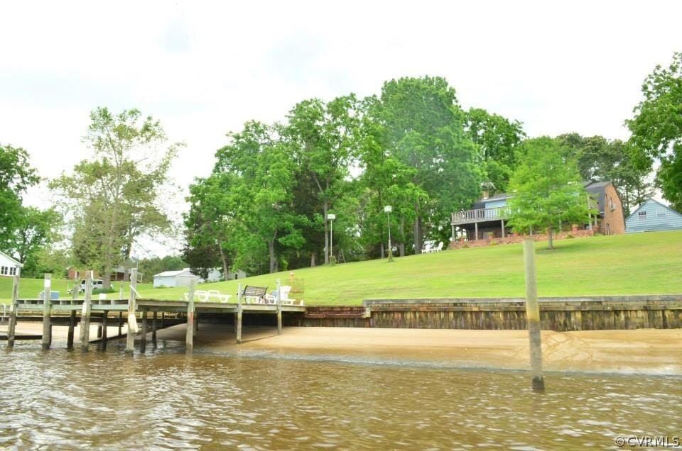 22 Foxes Tract Road West Point, VA 23181 - Photo 3 of 36 a view of a swimming pool with lawn chairs and large trees