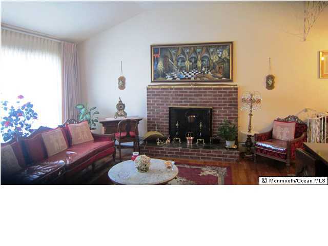 84 North Cooks Bridge Road Jackson, NJ 08527 - Photo 1 of 3 a living room with furniture and a fireplace