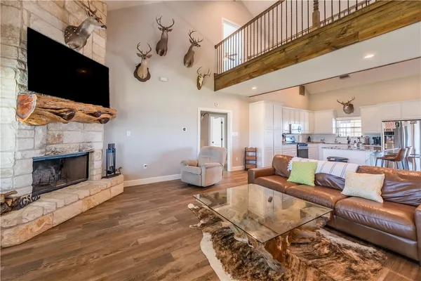 a living room with fireplace furniture and a flat screen tv