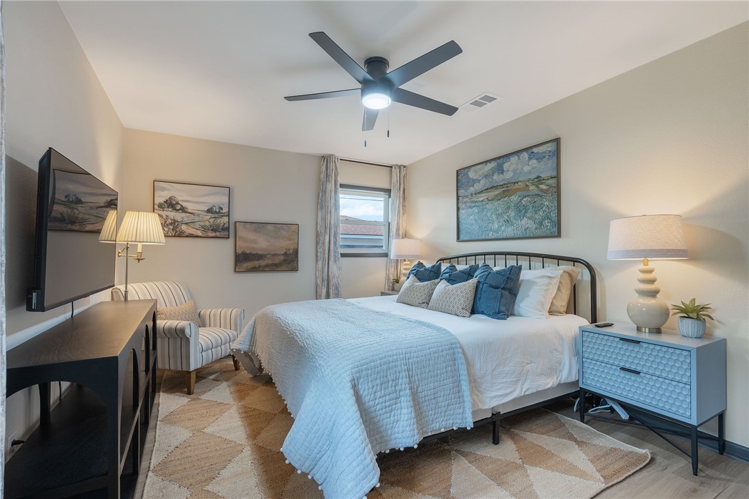 1509 Barak Lane Bryan, TX 77802 - Photo 16 of 24 a bedroom with a bed and a flat screen tv