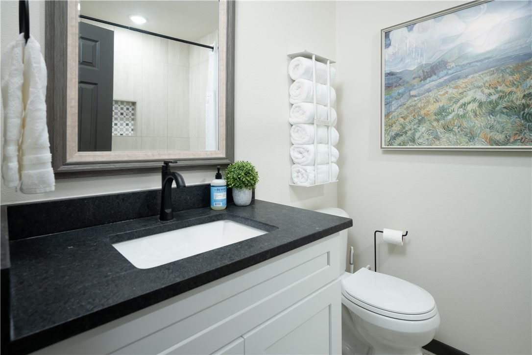 1509 Barak Lane Bryan, TX 77802 - Photo 20 of 24 a bathroom with a granite countertop sink and a mirror