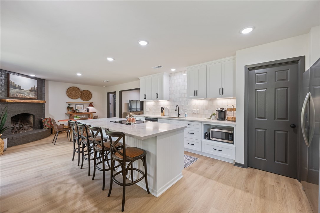 1509 Barak Lane Bryan, TX 77802 - Photo 6 of 24 a kitchen with kitchen island granite countertop wooden cabinets and stainless steel appliances