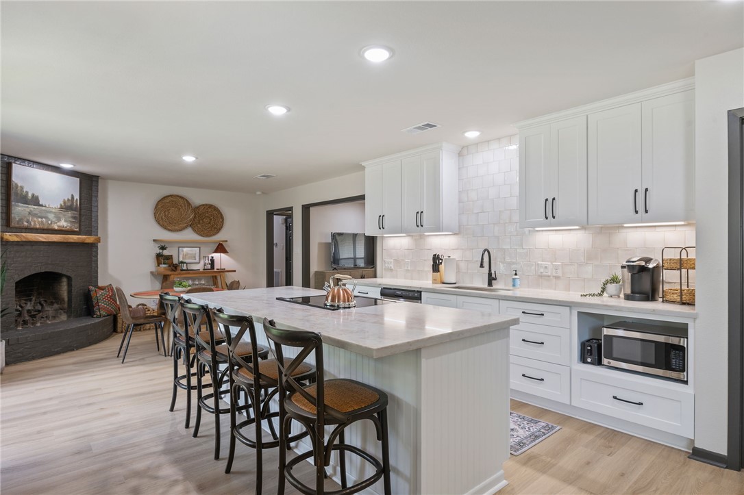 1509 Barak Lane Bryan, TX 77802 - Photo 7 of 24 a kitchen with a table chairs microwave and cabinets