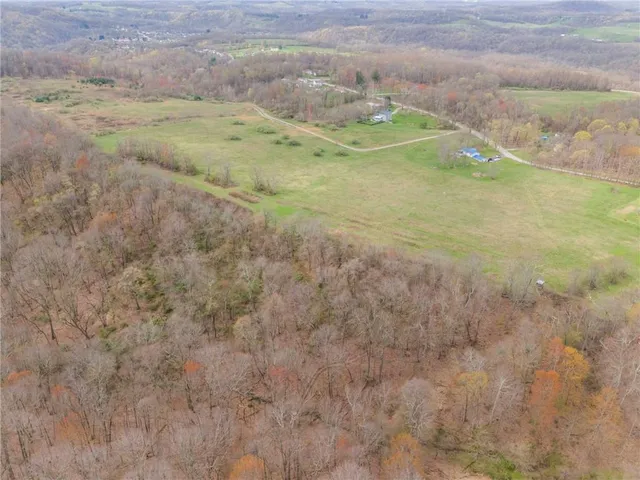 a view of a field with wooden fence