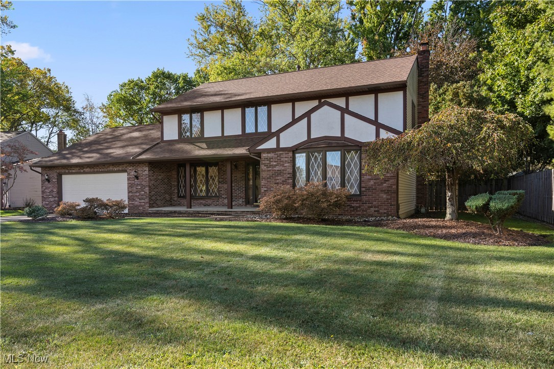1711 Gulf Road Elyria, OH 44035 - Photo 42 of 50 Tudor home with a chimney, brick siding, a garage, and a shingled roof