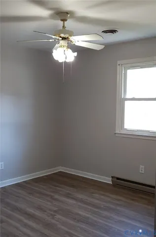 a view of a room with wooden floor