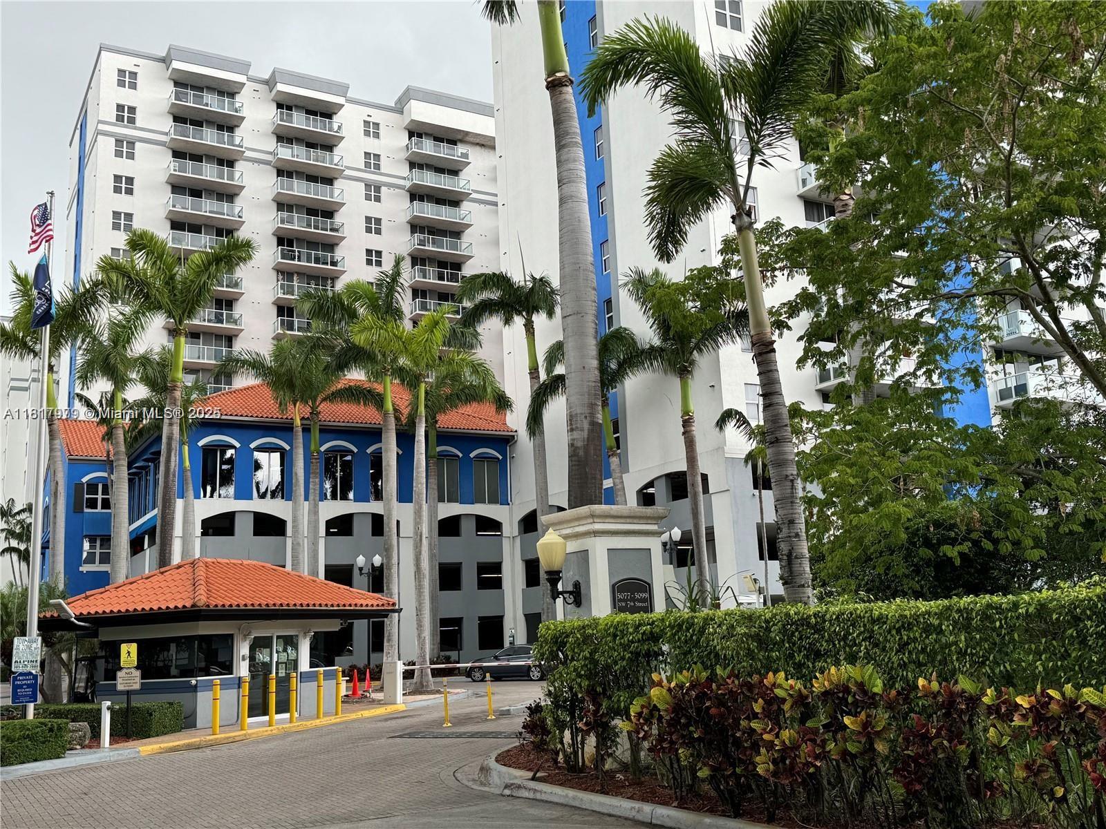 5091 Northwest 7th Street, Unit 615 Miami, FL 33126 - Photo 1 of 40 a front view of a multi story building with yard
