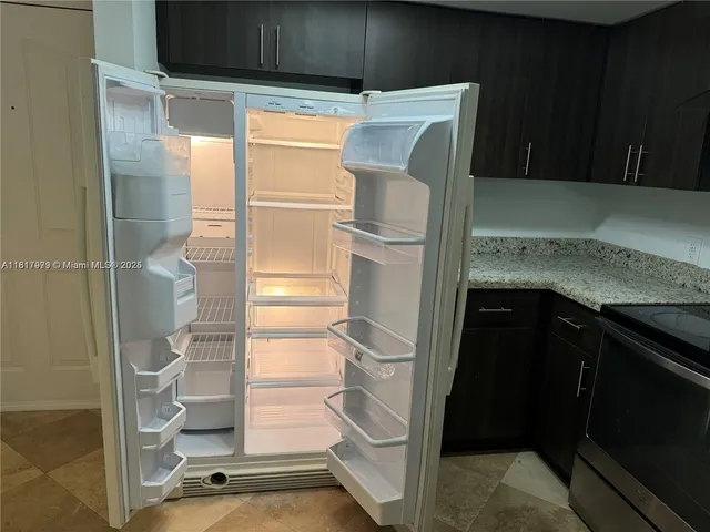 a kitchen with a refrigerator and cabinets