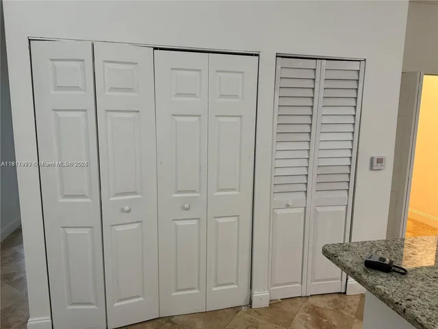 a view of a livingroom with an empty space and a window