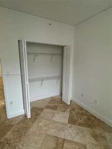 a bathroom with a granite countertop sink a toilet a mirror and shower