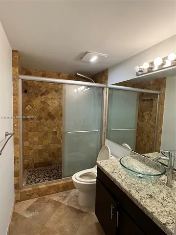 a bathroom with a shower and a sink
