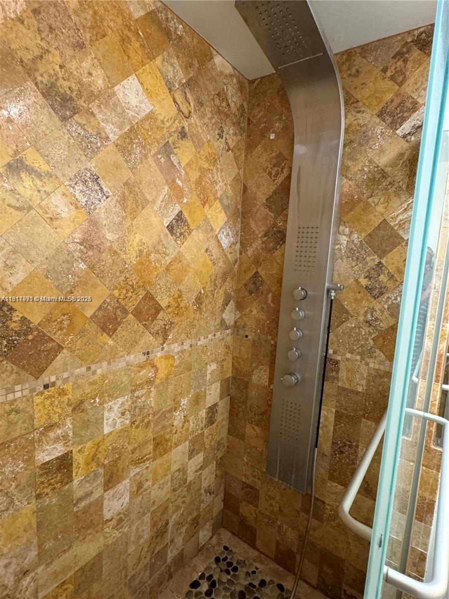 5091 Northwest 7th Street, Unit 615 Miami, FL 33126 - Photo 29 of 40 a bathroom with a shower and a sink